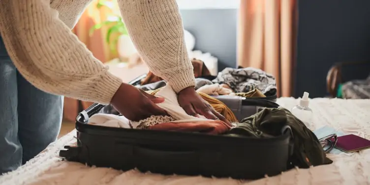 Woman packing her suitcase for holiday